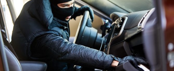 Thief-in-the-car-rummages-through-glove-compartment-for-garage-door-remote