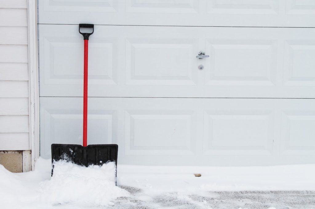 snow-shovel-white-garage-door