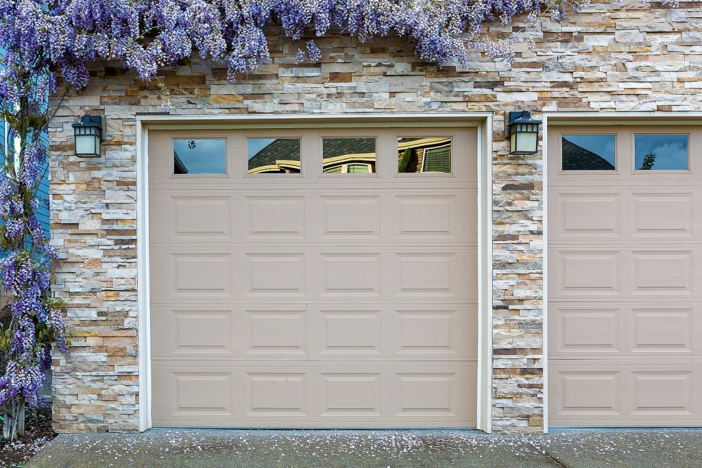 House-Front-with-Two-Beige-Garage-Doors-and-Wisteria-Growing-on-Wall