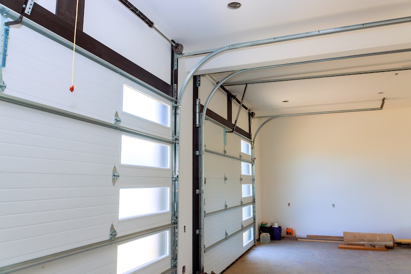 Compare torsion spring vs extension spring systems to learn how garage door springs work, their differences, benefits, safety, and maintenance needs.